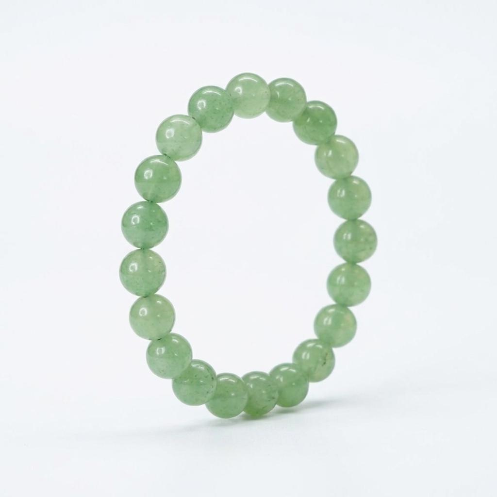 Green beaded bracelet on a white background